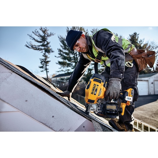 Cordless Coil Roofing Nailer being used by a construction worker on a roof