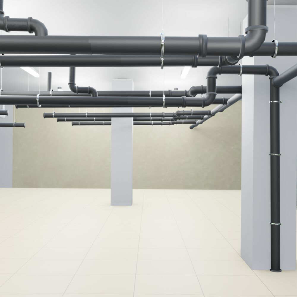 A basement with dark gray waste pipes on the ceiling